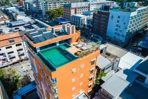 an overhead view of a building with a swimming pool on the roof at Phuket Patong Buri Resort in Patong Beach