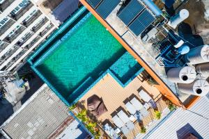 an overhead view of a swimming pool next to a building at Phuket Patong Buri Resort in Patong Beach +58 photos