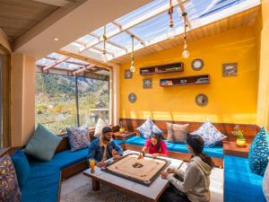 a group of people playing a board game on a table at Moustache Manali in Manāli