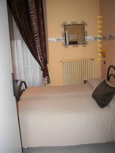 Postel nebo postele na pokoji v ubytování Albergo Sangrilà