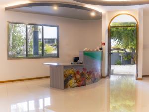 a lobby with a table and a painting on the wall at La Solara Villa in Ukulhas