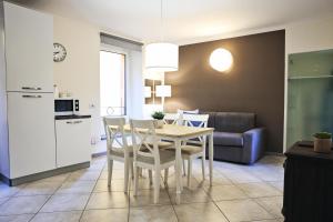 a kitchen and dining room with a table and chairs at Varennahouse in Varenna