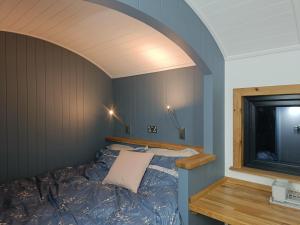 a bed in a room with an arched ceiling at Old Quay Escape in Tenby