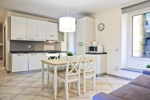 a kitchen and dining room with a table and chairs at Varennahouse in Varenna +46 photos