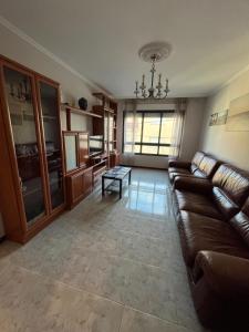 a living room with a couch and a table at Alquiler Vacacional en Ribeira in Ribeira
