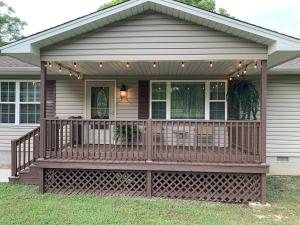 a house with a large wooden deck with lights on it at GabyHill in Davis