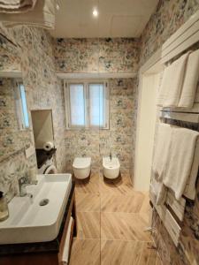 a bathroom with a sink and a toilet at Il Caruggio Townhouse in Varazze