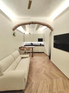 a living room with a couch and a table at Il Caruggio Townhouse in Varazze