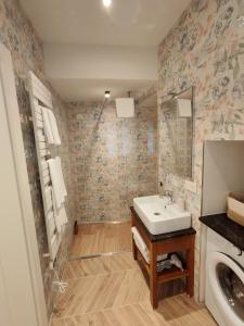 a bathroom with a sink and a washing machine at Il Caruggio Townhouse in Varazze