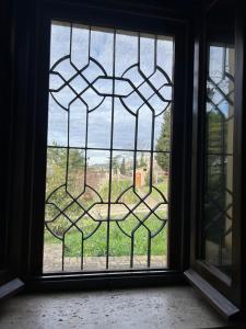 a window with a view of a field through it at Casa per Ferie Ulivo d'Assisi in Assisi