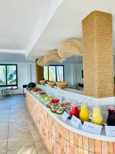 a buffet line with many different types of food at AnoMansa Beach Resort at Elmina Bay in Elmina