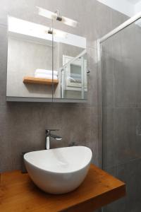a bathroom with a white sink and a mirror at Samà Housing in Larisa +37 photos