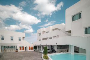 an exterior view of a building with a swimming pool at 레이니데이 in Namŭm-ni