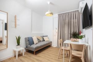 a living room with a couch and a table at Samà Housing in Larisa