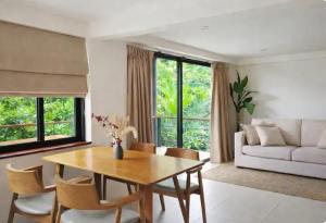a living room with a table and chairs and a couch at Exclusive Boho-Style 4-Bedroom Villa with Beautiful Private Tropical Pool, Spacious Outdoor BBQ & Chill-Out Terrace, Walking Distance to the Beach in Nathon Bay