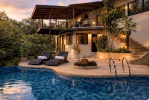a house with a swimming pool in front of a house at Exclusive Boho-Style 4-Bedroom Villa with Beautiful Private Tropical Pool, Spacious Outdoor BBQ & Chill-Out Terrace, Walking Distance to the Beach in Nathon Bay