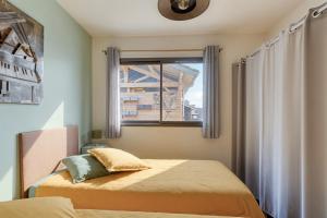a bedroom with two beds and a window at L'écrin de Sérénité - CNPE Bugey - Meximieux in Meximieux