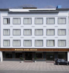 a hotel with a car parked in front of it at Hotel Sahil Suites in Katra