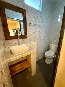 a bathroom with a sink and a toilet at Alena in Nusa Dua +7 photos