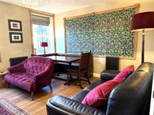 a living room with a couch and a table at Spinners View - NEW Renovated Apartment - Central Skipton & Parking in Skipton