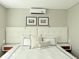 a bedroom with a large white bed with three pillows at Instellies Andringa Walk Apartment in Stellenbosch +39 photos