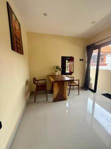 a living room with a wooden table and a desk at Alena in Nusa Dua