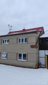 a large building with windows on the side of it at Chalupa Vyšní Lhoty in Vyšní Lhoty +2 photos