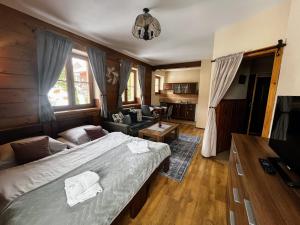 a bedroom with a bed and a living room at Vila Panorama in Ždiar