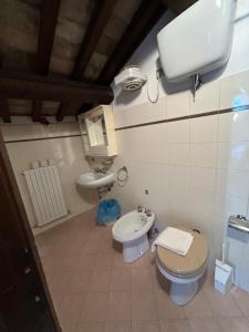 a small bathroom with a toilet and a sink at Casa per Ferie Ulivo d'Assisi in Assisi +15 photos