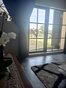 a living room with a large window and a rug at Farm under the stars in Vallentuna +29 photos