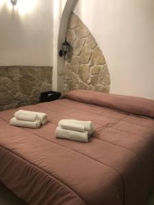 two towels sitting on top of a bed at B&B Santa Chiara Home in Caserta