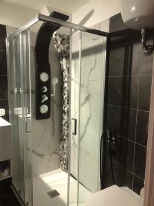 a shower with a glass door in a bathroom at B&B Santa Chiara Home in Caserta