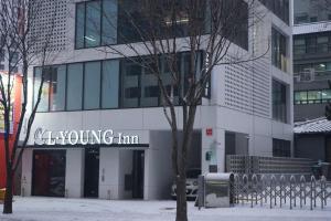 a building with a sign for a young inn at L YOUNG Inn Capsule Hotel Myeongdong in Seoul