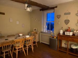a kitchen and dining room with a table and chairs at The Hideaway Embleton in Embleton +8 photos