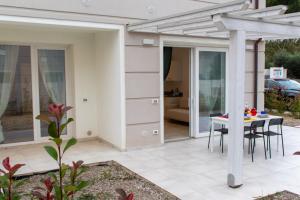 a patio with a table and a pergola at Margidore Beach in Lacona +12 photos