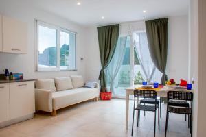 a living room with a couch and a table with chairs at Margidore Beach in Lacona