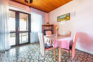 a dining room with a table and chairs at Apartmani Danijela in Stara Novalja