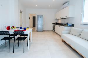 a kitchen and living room with a table and a couch at Margidore Beach in Lacona