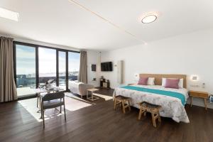 a bedroom with a large bed and a living room at Ocean View Lanzarote by Beyond in Tías +26 photos