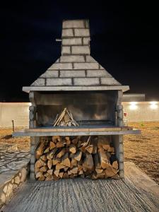 a pile of fire wood in an outdoor oven at House Villa Zvonko Near NP Krka in Sedramić