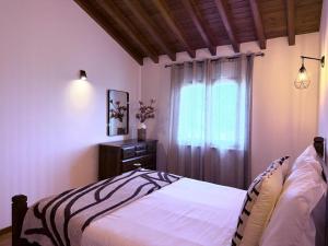 a bedroom with a bed and a mirror and a window at Azores Quinta do Segredo in Ponta Delgada