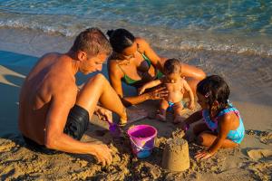 a group of people playing in the sand on the beach at Costa del Salento - CDSHotels in Lido Marini