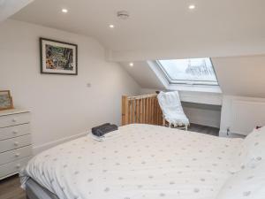 a bedroom with a bed and a chair and a window at 1 Castle Terrace in Thirsk