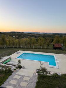an image of a swimming pool in a field at Casa Elena in Banja Luka