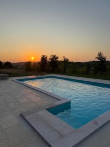 a swimming pool with a sunset in the background at Casa Elena in Banja Luka +18 photos