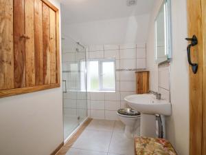 a bathroom with a toilet and a sink at 1 Dingle Cottage in Worcester +20 photos