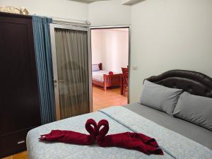 a bed with a pair of red hearts on it at Avatara A Ocean Views by malai in Ban Tha Fat +52 photos
