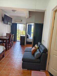 a living room with a couch and a dining room at Avatara A Ocean Views by malai in Ban Tha Fat