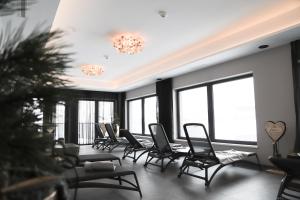 a waiting room with chairs and windows at A CASA Infinity in Serfaus