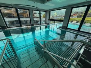 an indoor swimming pool in a building with windows at A CASA Infinity in Serfaus +289 photos